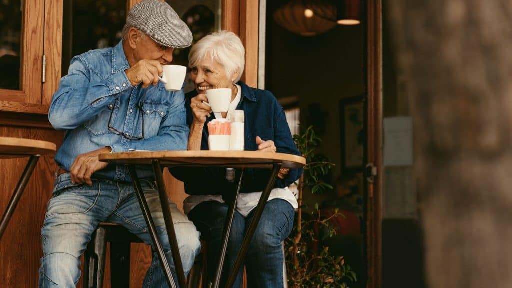 Retired couple who used to be a teacher and CPA enjoying coffee.